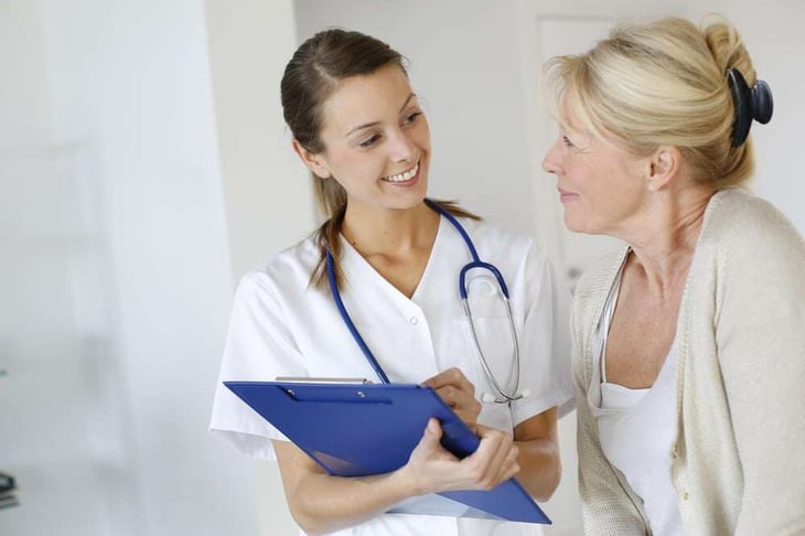 Nurse giving presciption to elderly woman-4