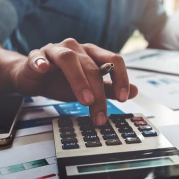 Business-accounting-concept,-Business-man-using-calculator-with-computer-laptop,-budget-and-loan-paper-in-office--941729686_3917x2611-1-1